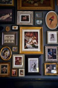 Discover a vibrant collection of framed art pieces elegantly displayed on a wall, showcasing diverse designs and sizes.